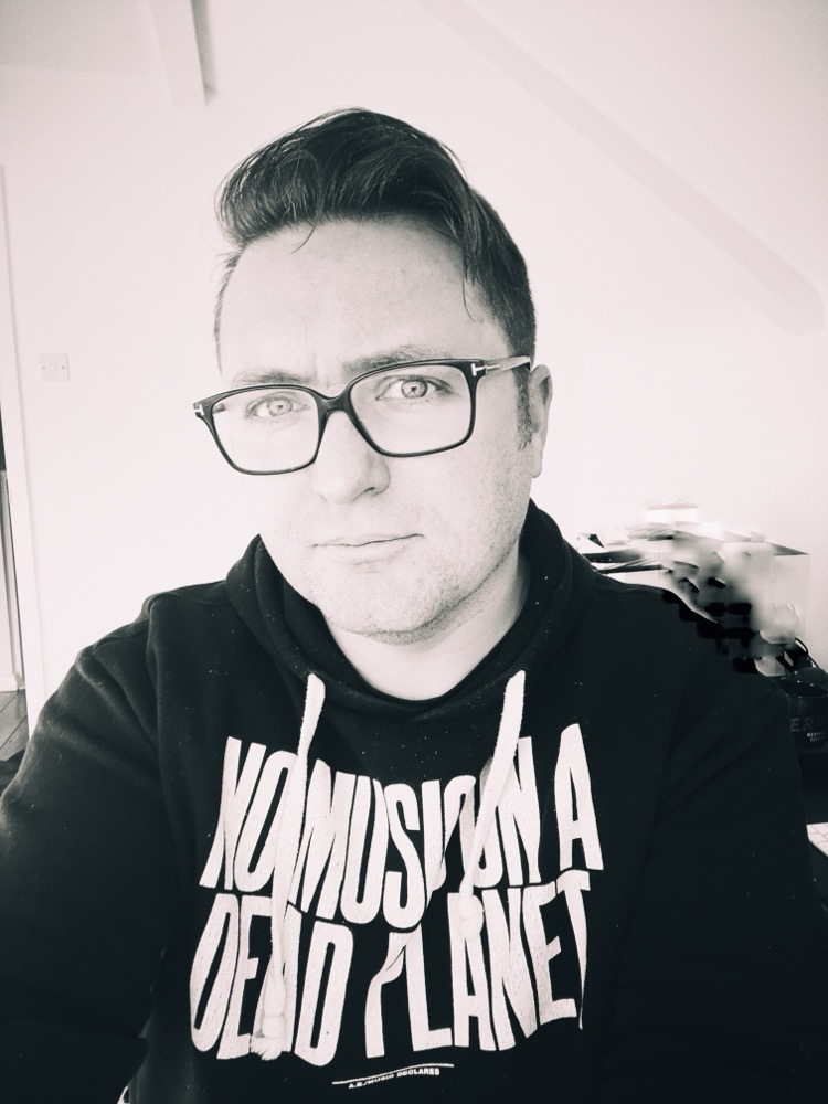 Sean Adams wearing a Music Declares Emergency 'No Music On A Dead Planet' hoodie